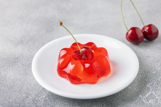 Glossy sweet cherry jelly dessert garnished with fresh cherry berry
