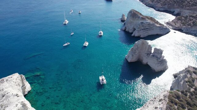 Sailboats in Kleftiko bay on Milos island in Greece during a sunny daytime aerial view