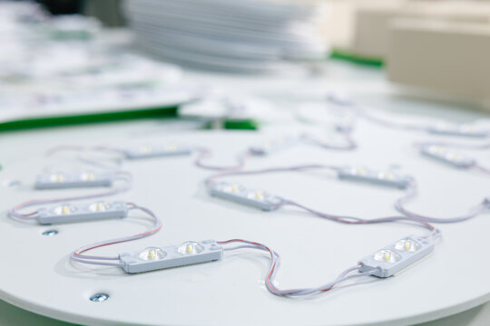Closeup led module wiring and diodes on circular panel for lighting product catalog