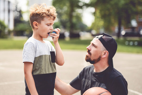 Boy with inhaler having breath problem