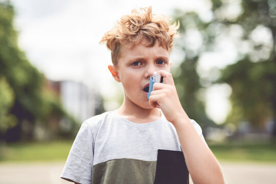 Boy with inhaler having breath problem