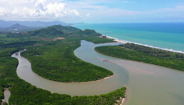 Serene meandering river winding through lush green valley with distant mountains.