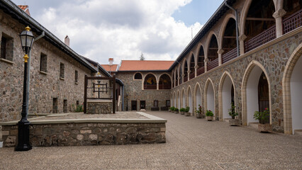 Fototapeta premium Stone courtyard surrounded by arched walkways