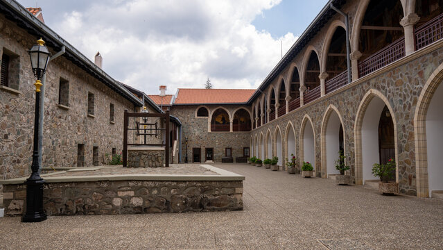 Stone courtyard surrounded by arched walkways