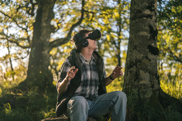 Obraz premium Man experiencing virtual reality outdoors in forest