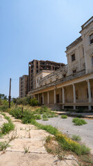 Fototapeta premium Broken columns stand beside overgrown grass