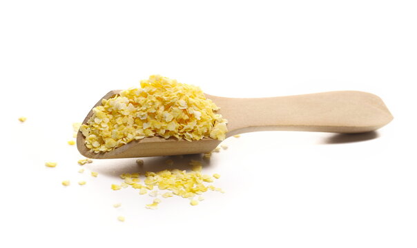 Corn flakes pile in wooden spoon isolated on white background, side view