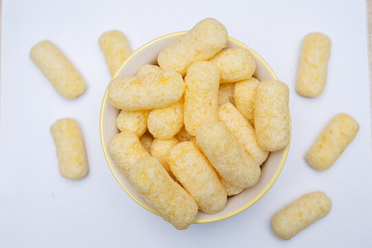 Yellow Puffed Corn Snacks on White Background