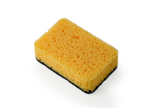 Bright yellow sponge resting on a clean white surface, showcasing its textured surface and vibrant color, ready for cleaning tasks or artistic endeavors