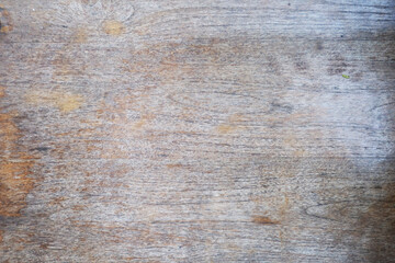 Fototapeta premium Weathered wood texture with faded grain patterns and rustic grey brown tones. Aged wooden surface ideal for furniture, wall panels, flooring, interior design, and architectural backgrounds.