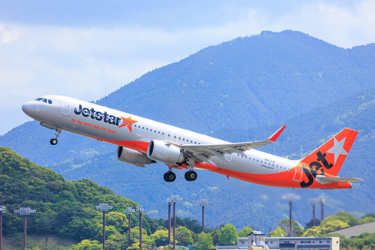 A Jetstar Japan Airbus A320 taking off with a mountain behind on May 10, 2025 in Fukuoka, Japan.