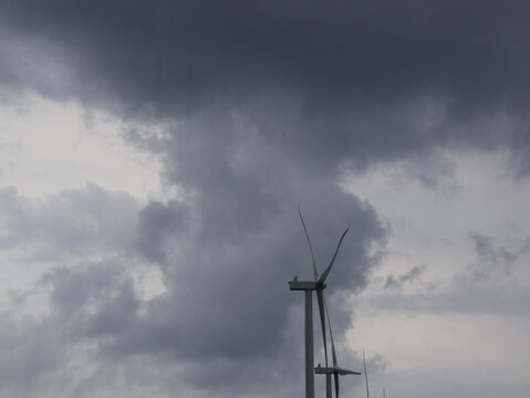 Wind Turbines Beneath Dramatic Storm Clouds