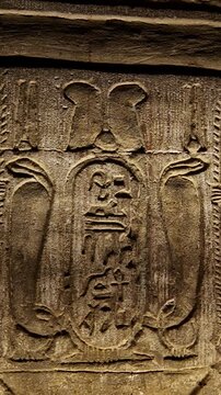 Hieroglyphs and images of Egyptian gods at the Ancient Egyptian Temple of Edfu. Edfu is the site of a Ptolemaic-era Temple of Horus and an ancient settlement in Egypt