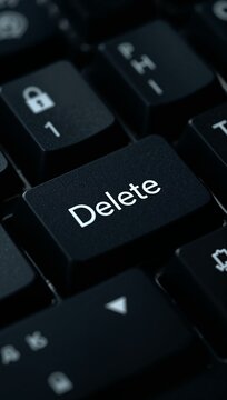 Computer keyboard with a highlighted Delete key symbolizing data removal, digital security, file management and modern computing.