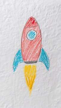 Child's hand-drawn rocket launching into space with colorful flames illustrating imagination, creativity and playful space exploration.
