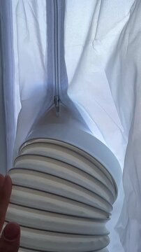 Portable mobile air conditioner exhaust tube evacuated through airtight white polyester window sealing cloth installation	