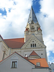 Fototapeta premium Beautiful Romanesque revival church tower with red tiled roof in Lodz Poland