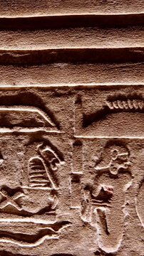 Hieroglyphs and images of Egyptian gods at the Ancient Egyptian Temple of Edfu. Edfu is the site of a Ptolemaic-era Temple of Horus and an ancient settlement in Egypt