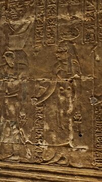 Hieroglyphs and images of Egyptian gods at the Ancient Egyptian Temple of Edfu. Edfu is the site of a Ptolemaic-era Temple of Horus and an ancient settlement in Egypt