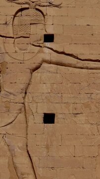 Massive pylon facade of Edfu Temple with giant pharaoh reliefs and central gateway, Egypt. Best preserved ancient Egyptian temple exterior for travel and history projects