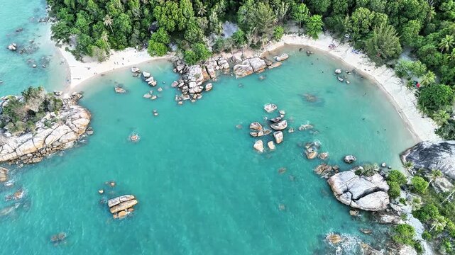 Aerial drone view of Teluk Karang Beach Bangka revealing turquoise tropical bay, granite boulders, white sand coves and untouched island paradise