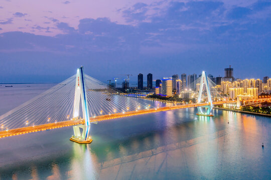High angle night view of Century Bridge over Haidian River in Haikou, Hainan, China