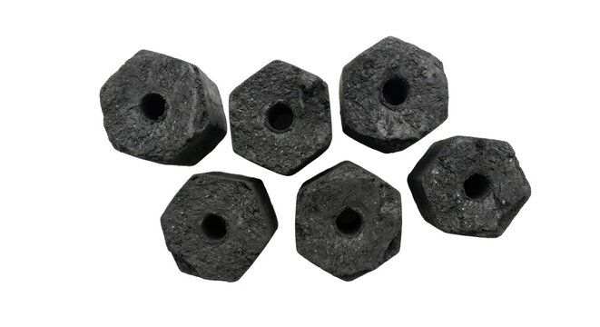 Close-up of six hexagonal charcoal briquettes on a white background