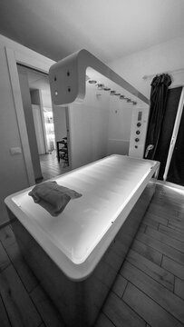Minimalist spa treatment room with massage bed in