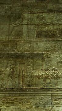 Hieroglyphs and images of Egyptian gods at the Ancient Egyptian Temple of Edfu. Edfu is the site of a Ptolemaic-era Temple of Horus and an ancient settlement in Egypt
