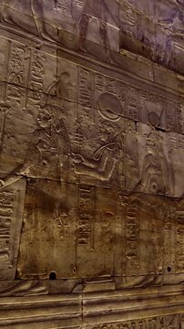 Hieroglyphs and images of Egyptian gods at the Ancient Egyptian Temple of Edfu. Edfu is the site of a Ptolemaic-era Temple of Horus and an ancient settlement in Egypt