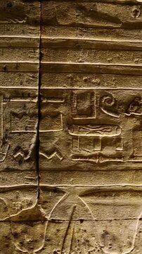 Hieroglyphs and images of Egyptian gods at the Ancient Egyptian Temple of Edfu. Edfu is the site of a Ptolemaic-era Temple of Horus and an ancient settlement in Egypt