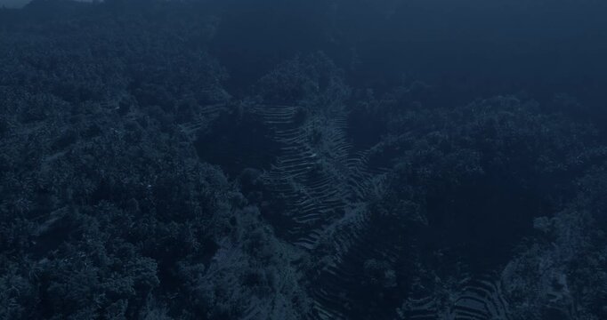 Bird's eye view on rice terraces in China at night. Camera is moving backward