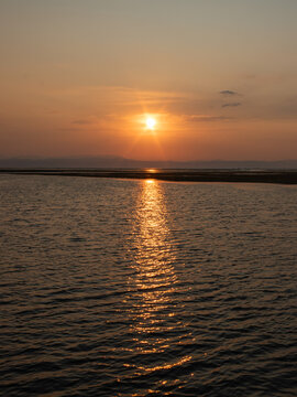 Golden sunrise reflected over the Adriatic Sea at Grado Pineta, Friuli Venezia Giulia, Italy