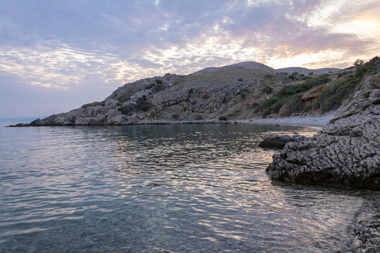 Calm Adriatic Sea and rocky coastline at sunset near Stara Ba&scaron;ka, Krk Island, Croatia