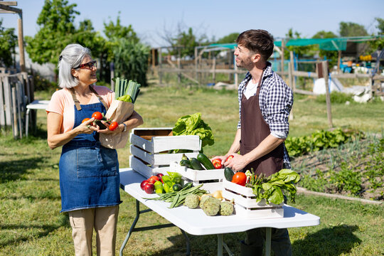 People selling fresh organic produce at local market