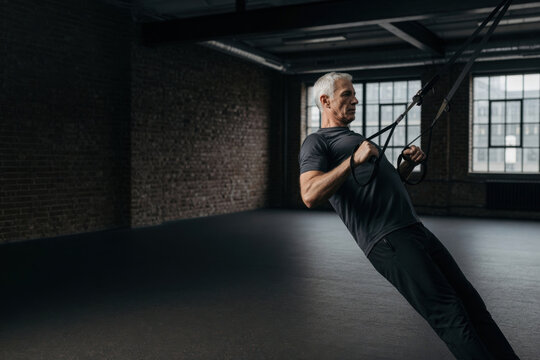 Senior man workout suspension fitness older male exercising in gym athlete training strength indoors active retirement healthy lifestyle motivation Active senior fitness concept