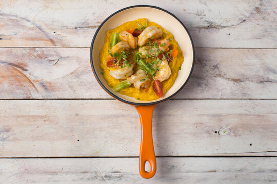 Traditional Brazilian shrimp bobo served in a ceramic pan on a rustic table.