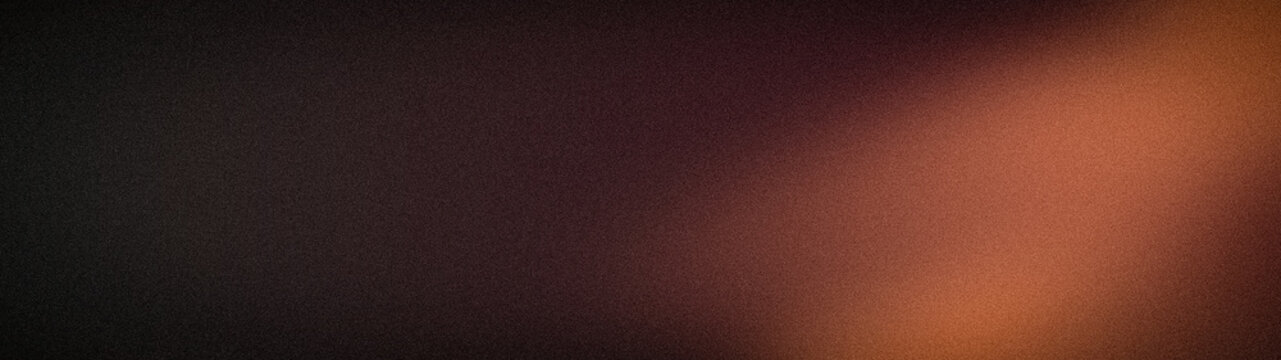 Abstract grainy textured background design in black brown and burnt orange with wide format and gradient effect