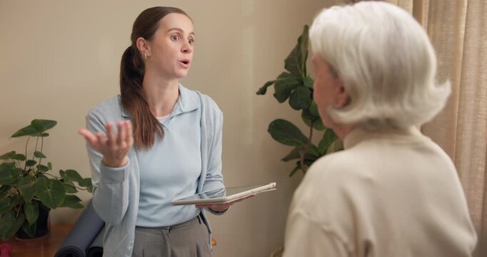 Senior, woman and physiotherapist on tablet for consulting, report and healing for osteoarthritis. Healthcare, tech and physical therapist with patient for wellness, advice and support for mobility