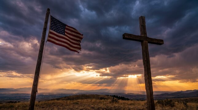 An American flag and a wooden cross stand tall on a hilltop against a dramatic sky, illuminated by rays of sunlight.