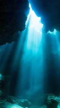 Rays Sunlight piercing through the entrance of an underwater cave. A fantastical natural scene that illuminates the silent darkness in blue.derwater cave