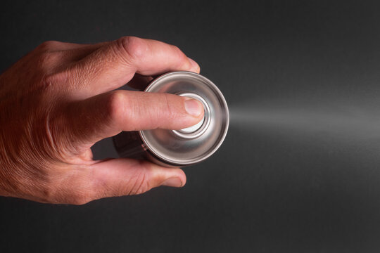 Hand Pressing Aerosol Spray Can Top View