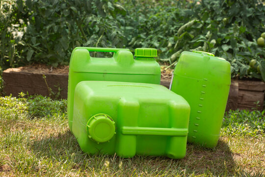 Plastic Chemical Canisters in Vegetable Garden