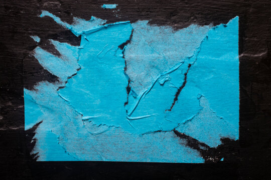 Paper texture, blue torn poster with folds close-up