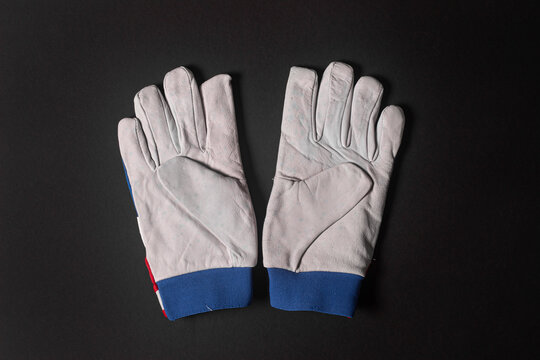 White Leather Work Gloves on Dark Background