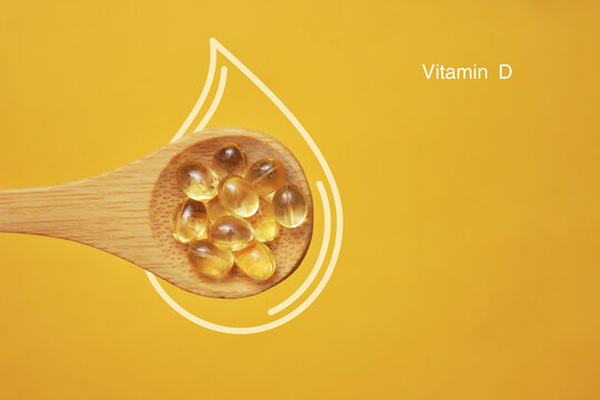 Vitamin D Capsules in Wooden Spoon