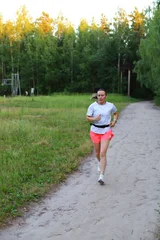 Adult European Woman Running in Open Stadium.  © Anton Belovodchenko