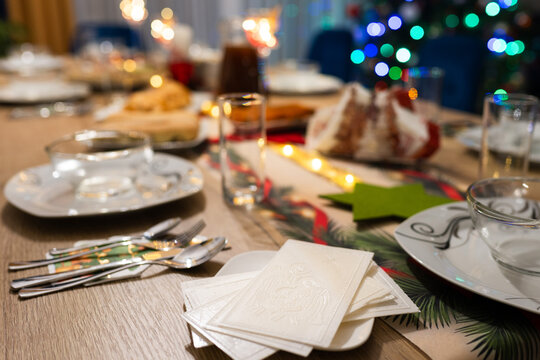 Close-up of traditional Polish Christmas wafers (opłatek) on a decorated dinner table, a symbolic element of Christmas Eve celebrations in Poland.
