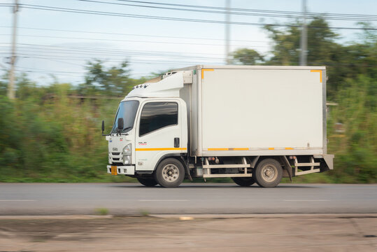 Nakhonsawan, Thailand - Oct, 2025: Isuzu NLR 130 truck, A white small truck for transportation, Driving at high speed on the nation highway no.117 on October 24, 2025 in Nakhon Sawan, Thailand.