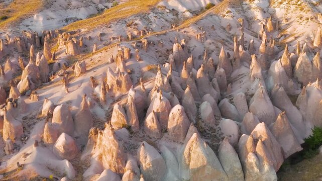 Goreme, Nevsehir, Turkey. Devrent Valley fairy chimneys and eroded tuff spires, aerial panoramic view at golden hour sunset over the lunar landscape. Aerial View, MasterShots, Circle (Close)